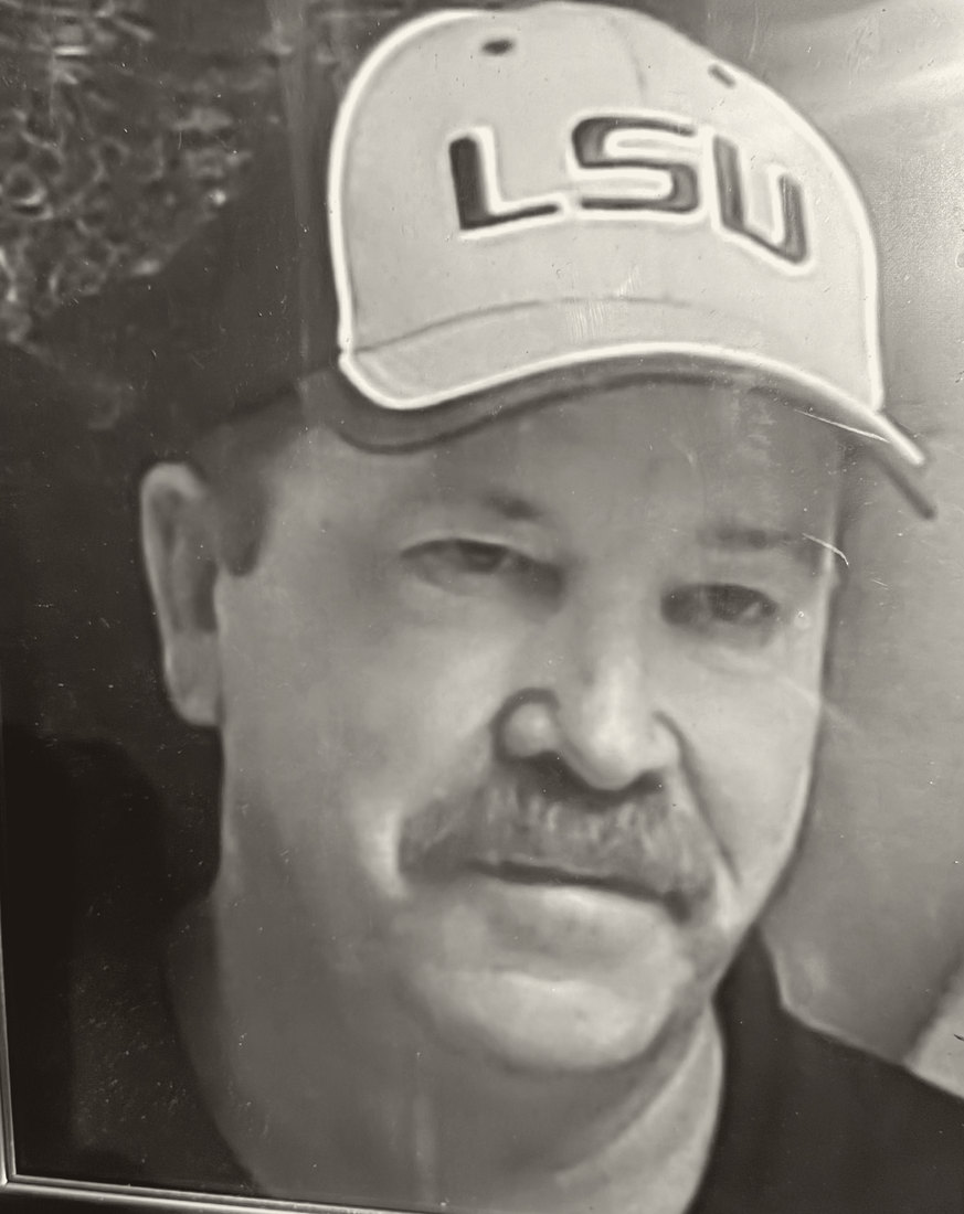 Portrait of Don Hanes, wearing an LSU cap.